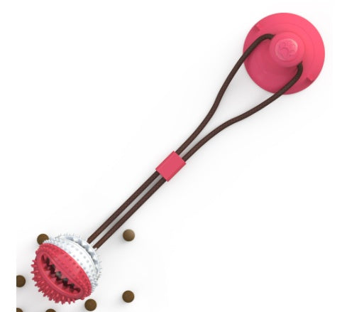 Red suction cup dog toy with textured chew and treat ball